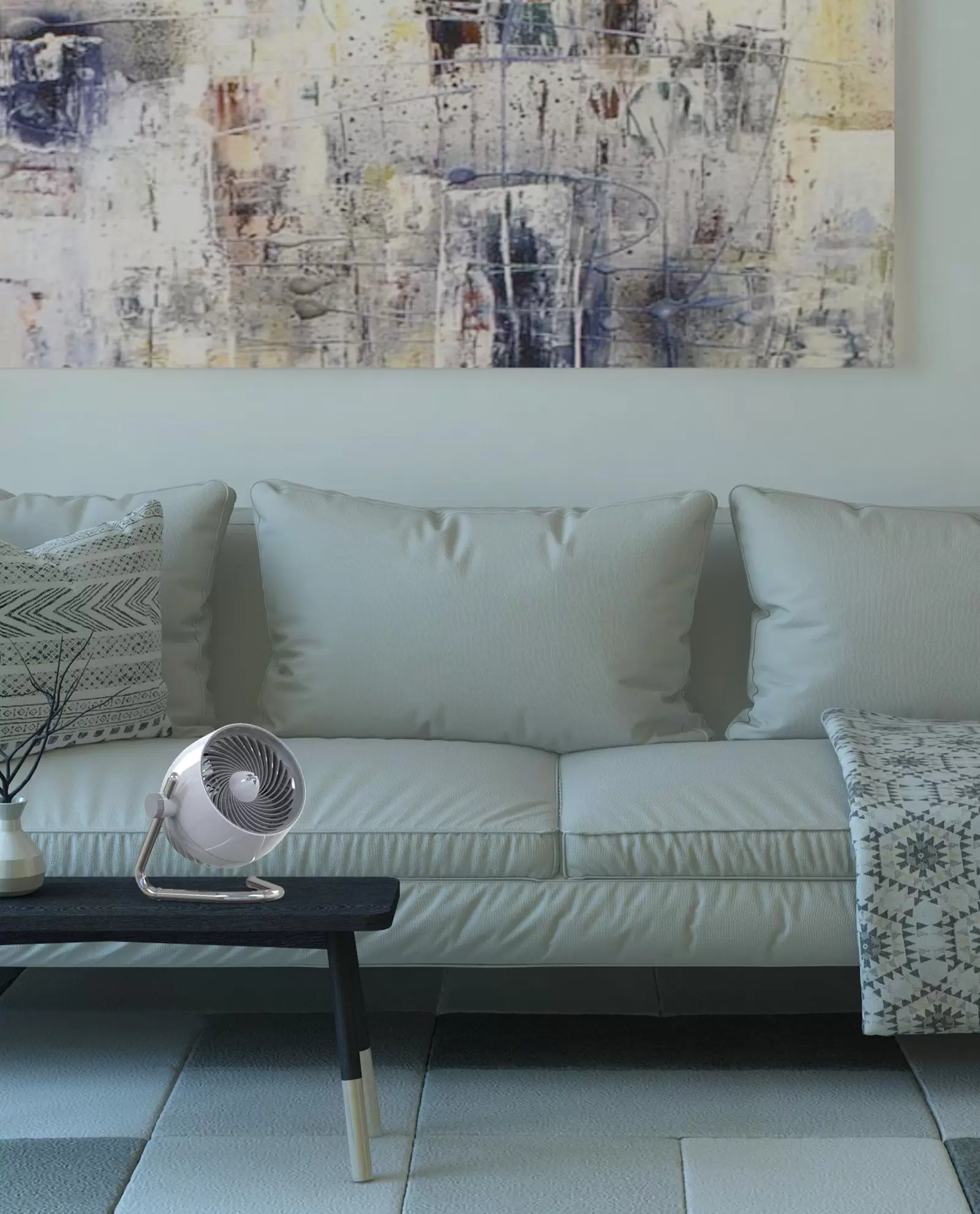 Pivot5 small air circulator on a coffee table in front of a light colored couch