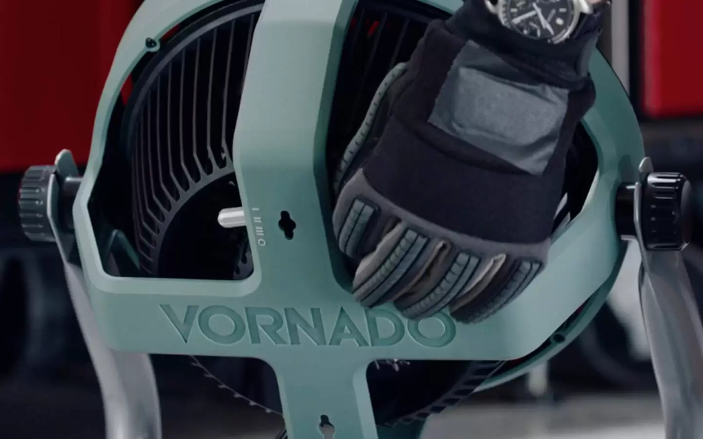 EXO61 HD Controls A gloved hand adjusting EXO61 HD fan Controls