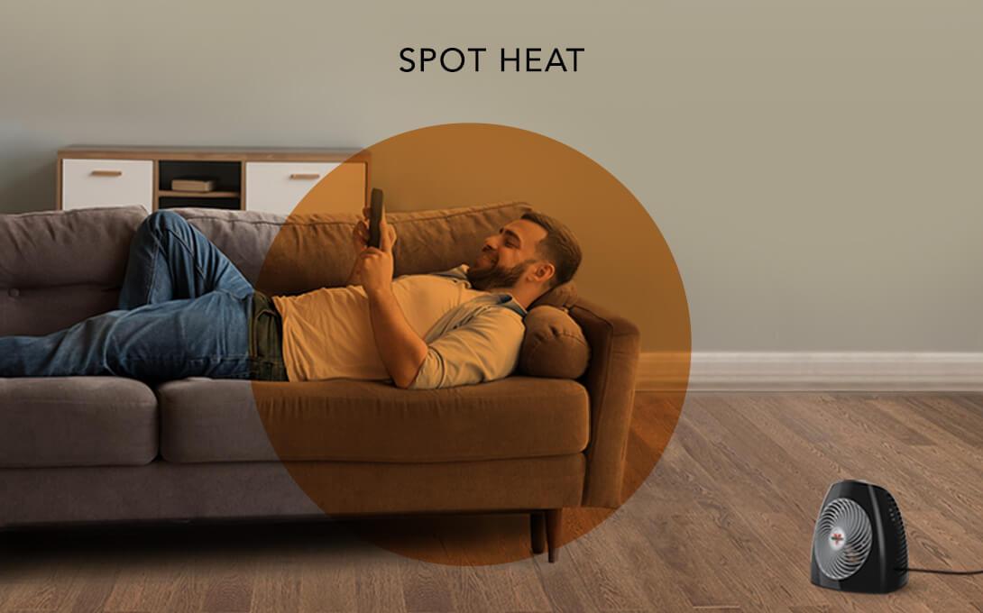 MVH Spot Heat Man laying on a couch with the MVH heater on the floor. There is an orange circle overlay on him to indicate a spot heat space.