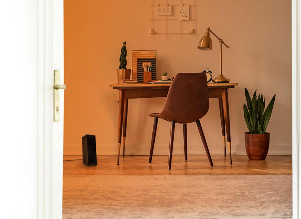 Study desk through an open door with an orange gradient to show whole room heat circulation. Rise 12H is on the floor.