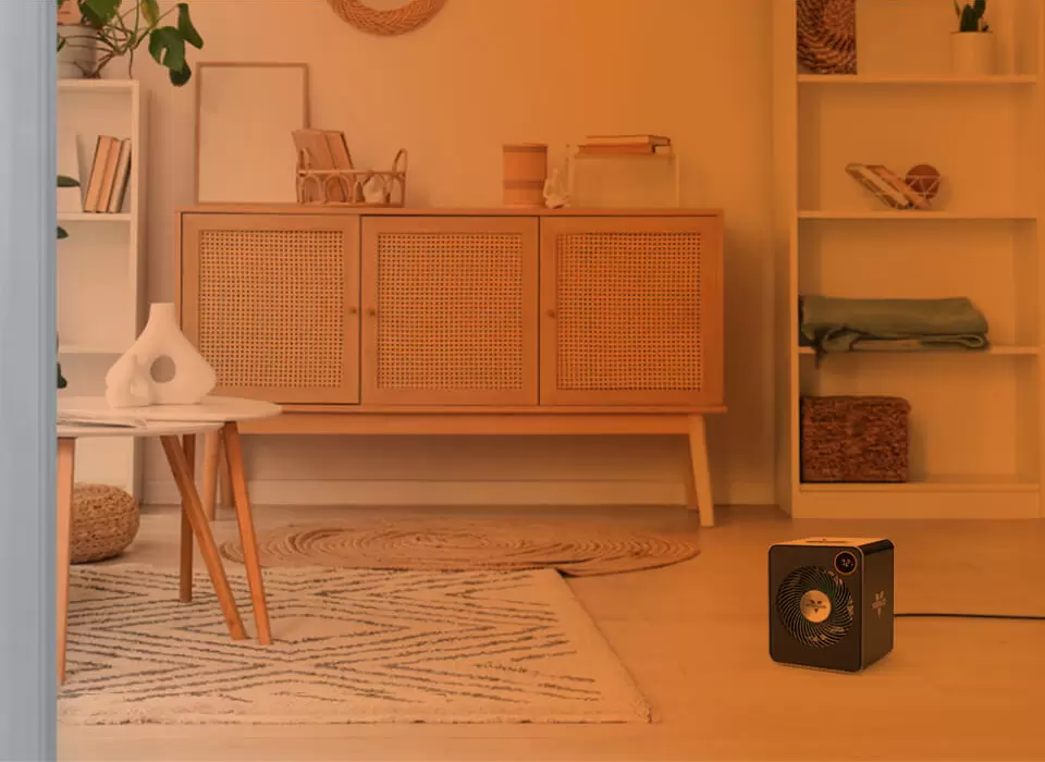 VMHi600 Heat Circulation Part of a living room seen through an open door with an orange gradient to show whole room heat circulation. VMHi600 on the floor.