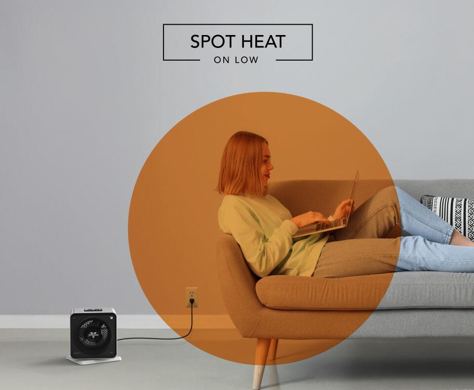 Velocity Cube 5S Spot Heat Woman laying on a couch with the Velocity Cube 5S heater on the floor. There is an orange circle overlay on her to indicate spot heat on low.