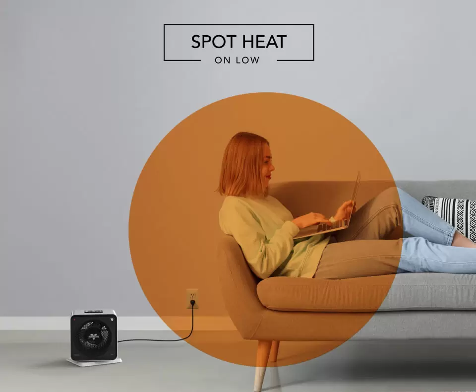 Velocity Cube 5S Spot Heat Woman laying on a couch with the Velocity Cube 5S heater on the floor. There is an orange circle overlay on her to indicate spot heat on low.