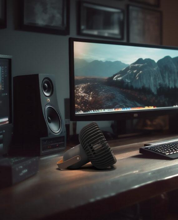 Vornado FLY MOVE sitting on the desk of a desktop workstation