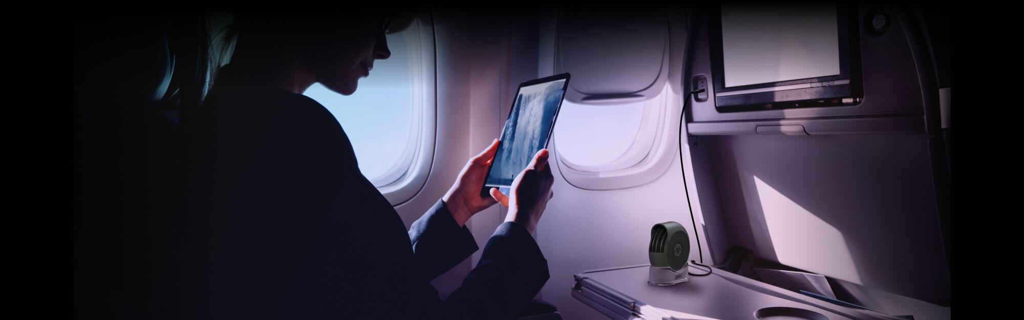 Airflow on the Go Pebl A woman using the Pebl Portable Fan on an airplane.
