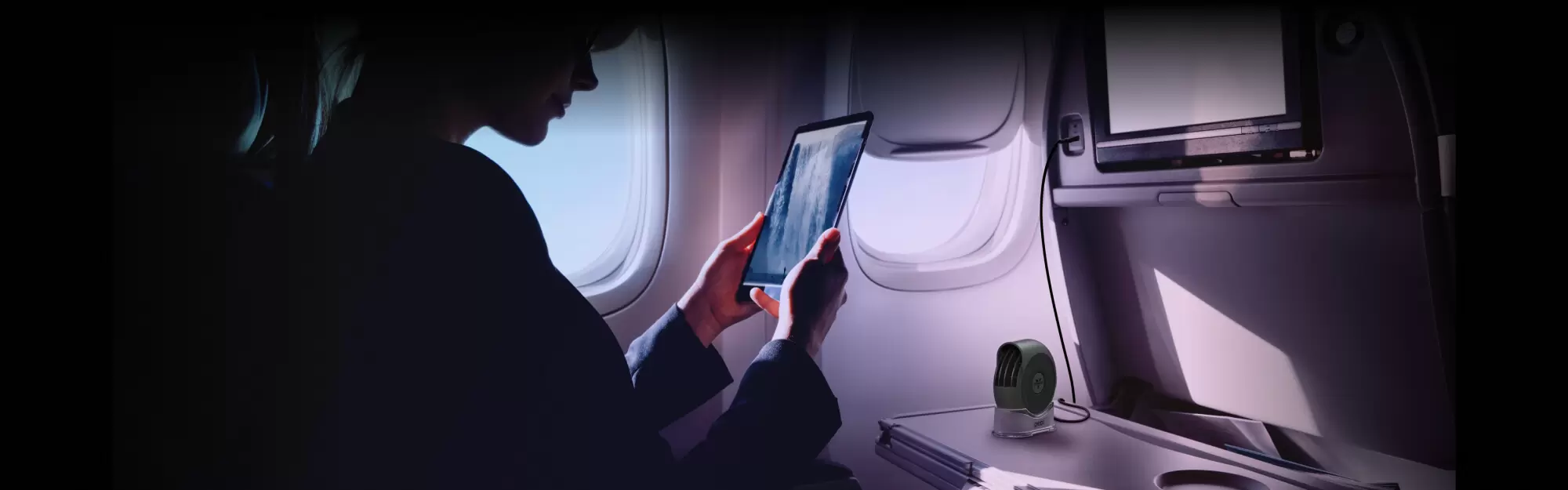 Airflow on the Go Pebl A woman using the Pebl Portable Fan on an airplane.