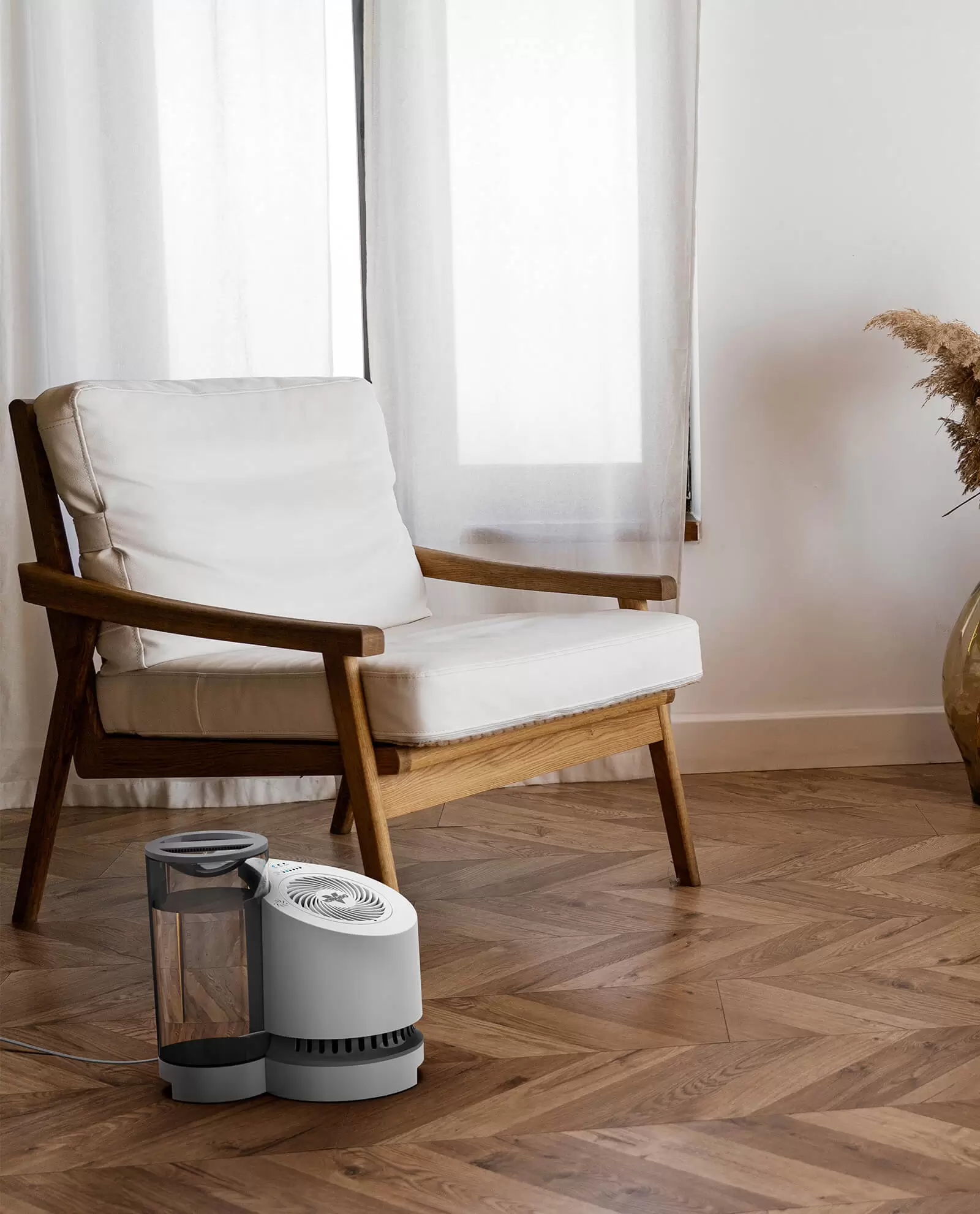 lifestyle of a ev100 evaporative humidifier in a living room near a chair