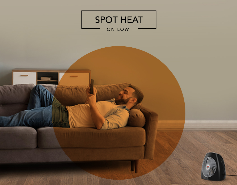 MVH Spot Heat Man laying on couch with the MVH heater on the floor. There is an orange circle overlay on him to indicate spot heat on low.