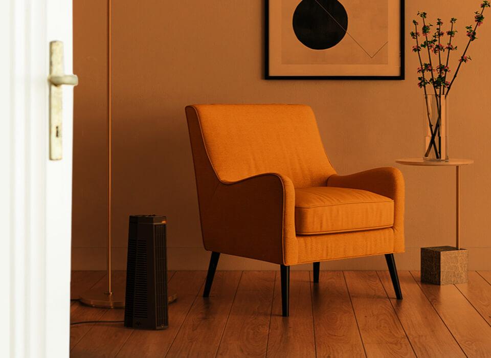 Chair seen through an open door with an orange gradient to show whole room heat circulation. Rise 12H is on the floor nearby.
